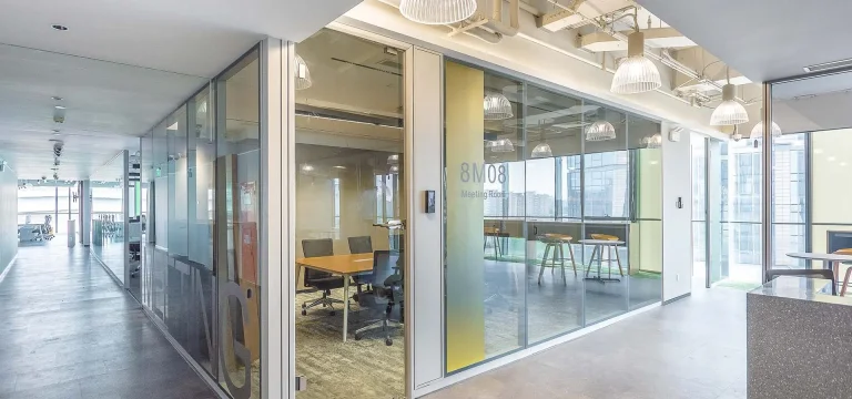 Office zoning plan checklist illustrated by an aluminum-framed glass meeting room