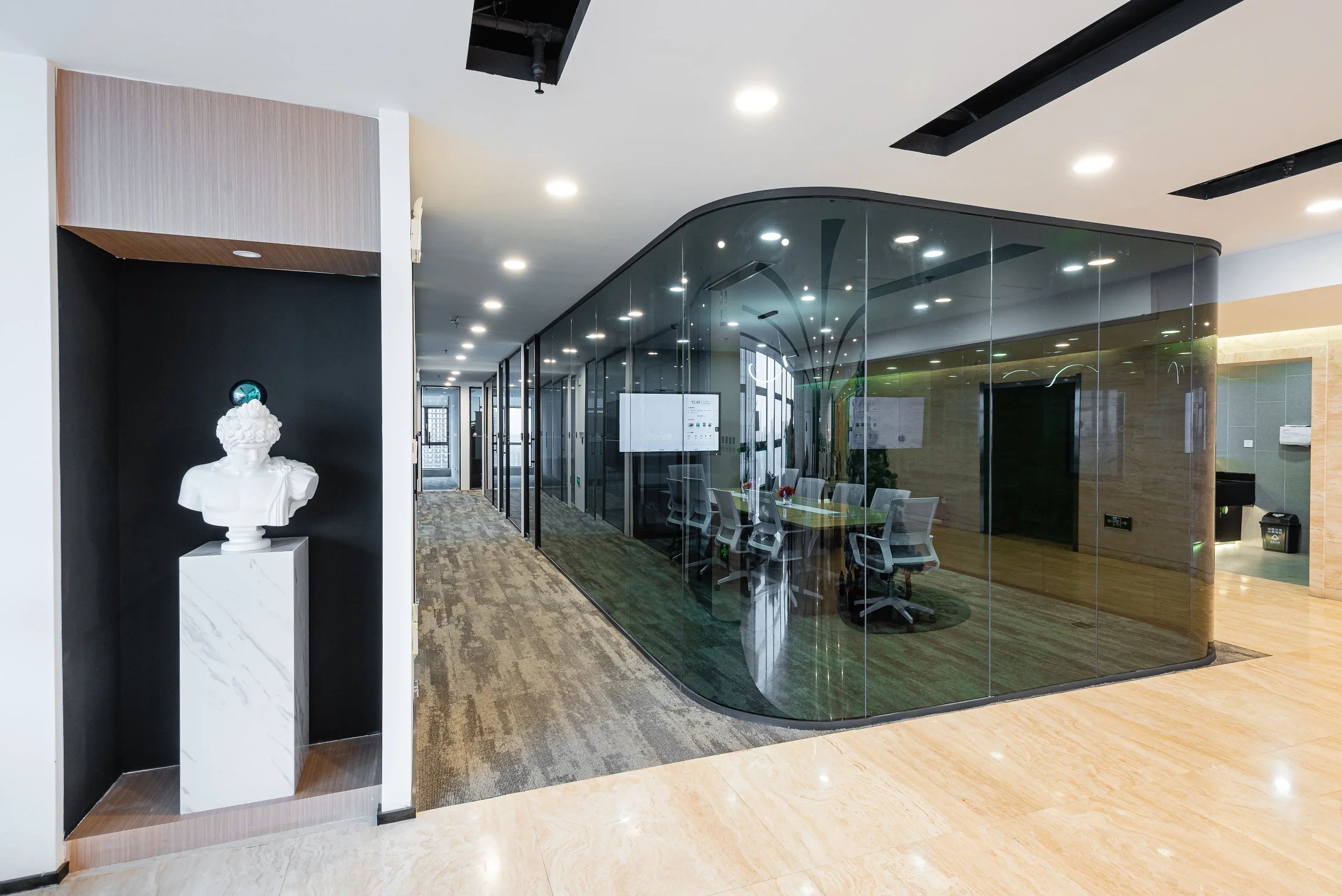 Custom curved frameless glass partition meeting room in modern coworking office