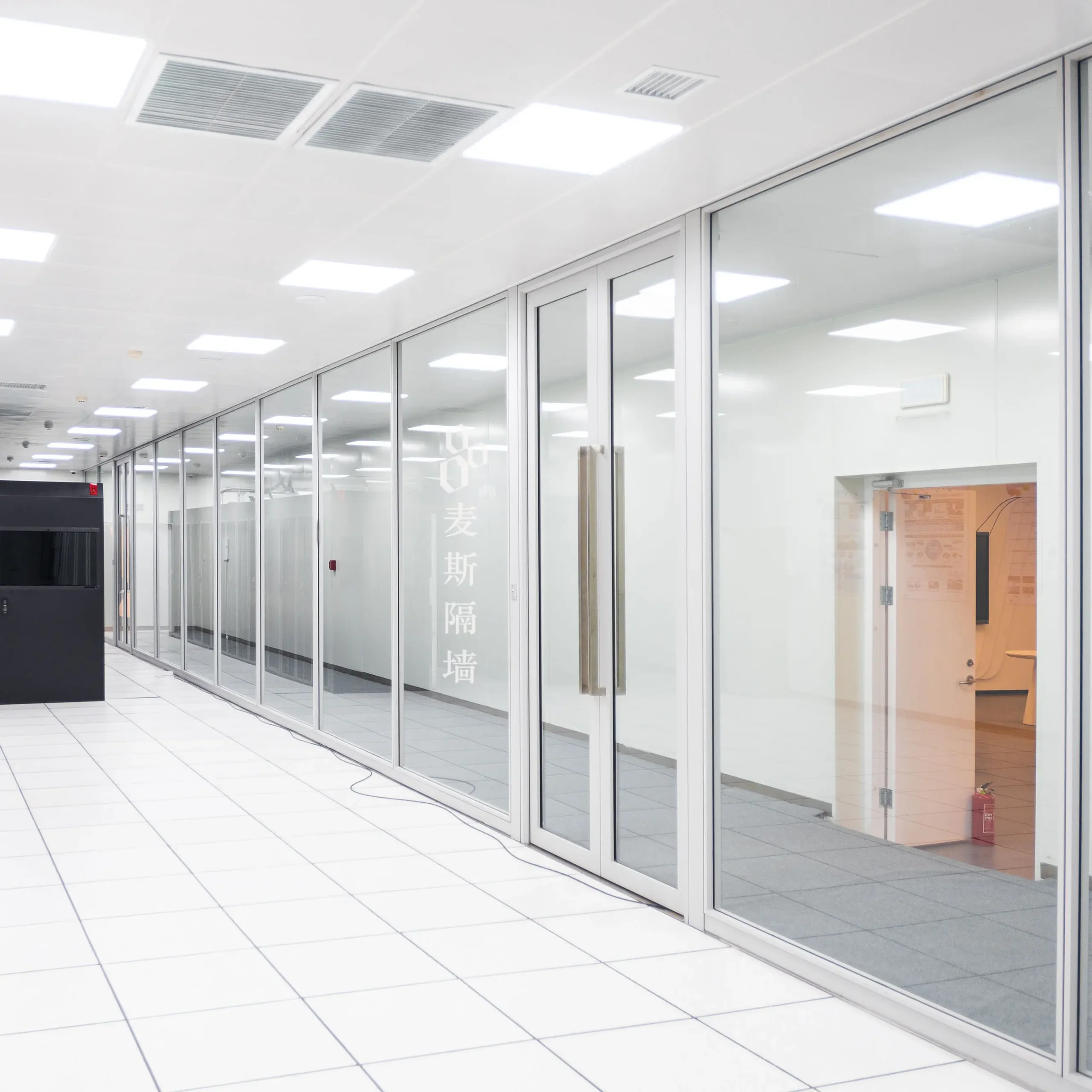 Office partition systems in a visible-frame configuration — white aluminium framed glass partition run with a glazed double door along a clean-room corridor