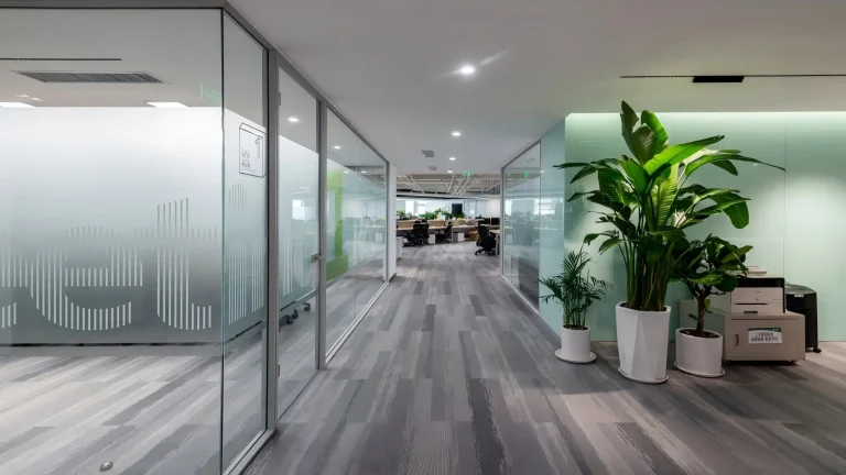 Aluminum framed decorative glass partition along office corridor with frosted privacy graphics (Planning & Design Institute project)