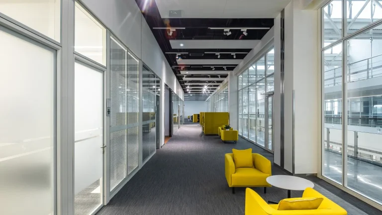 Aluminum framed glass partition in office corridor with lounge seating (BMW Brilliance Tiexi project)