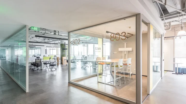 Frameless glass partition system creating numbered office pods in coworking workspace (Longfor Group Beijing - MY SPACE project)