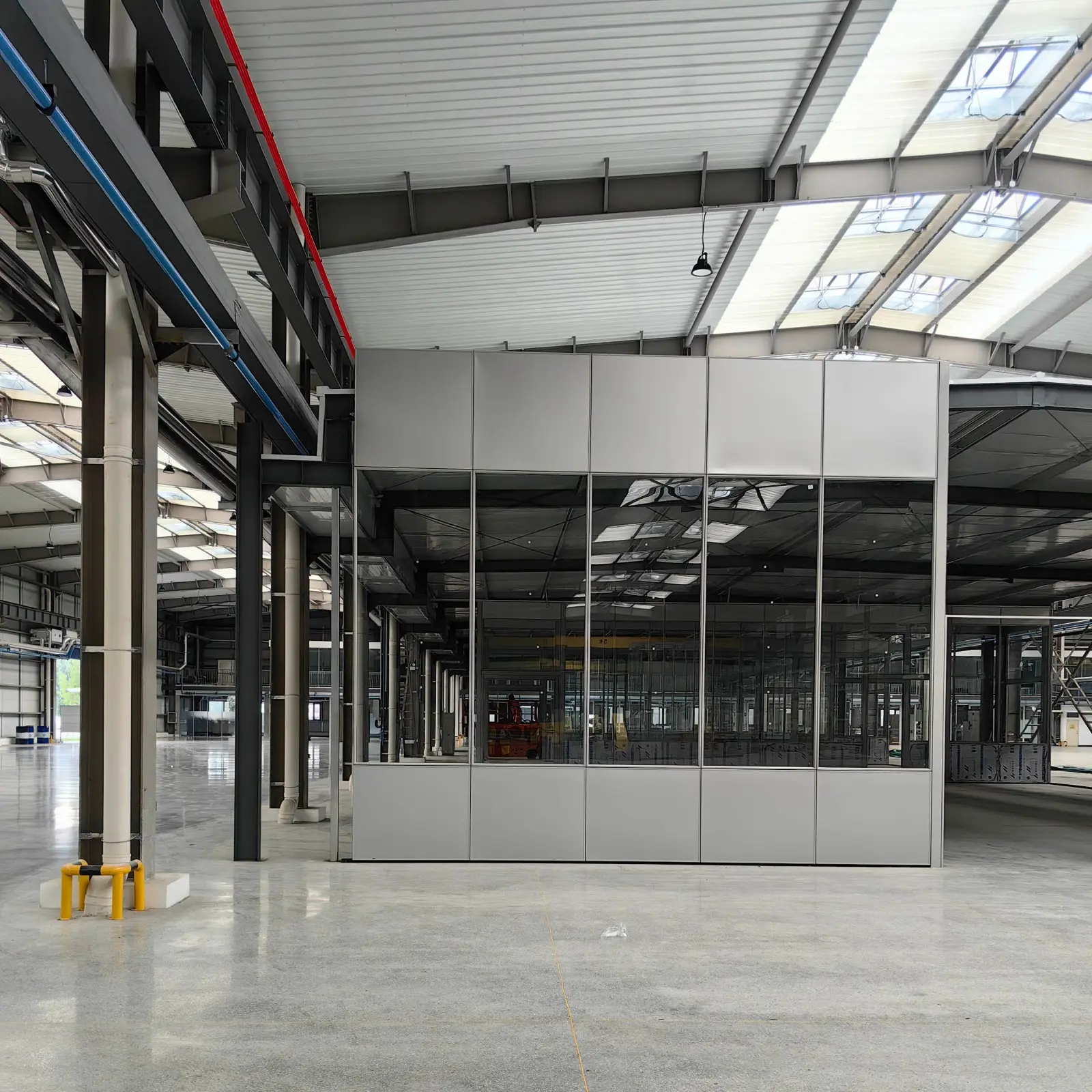 Commercial solid partitions installation in industrial office environment showing modular aluminum-framed panel system