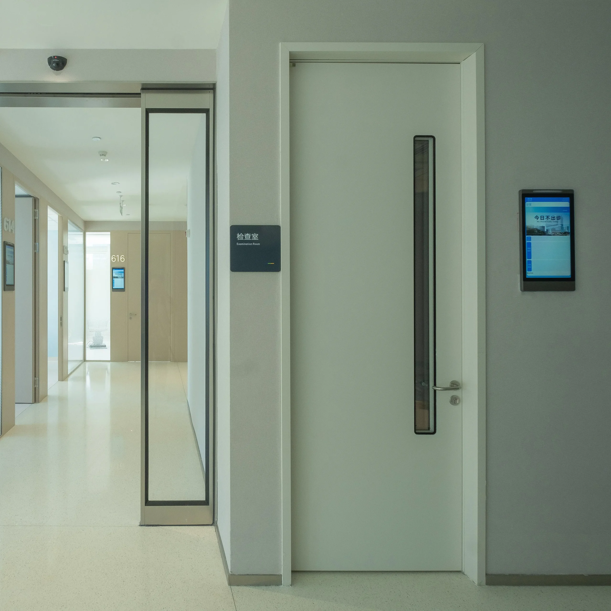 Steel personnel door on an examination room opening in a controlled-access area